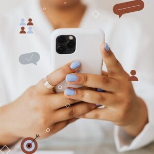 Close-up of person holding smartphone surrounded by digital icons.